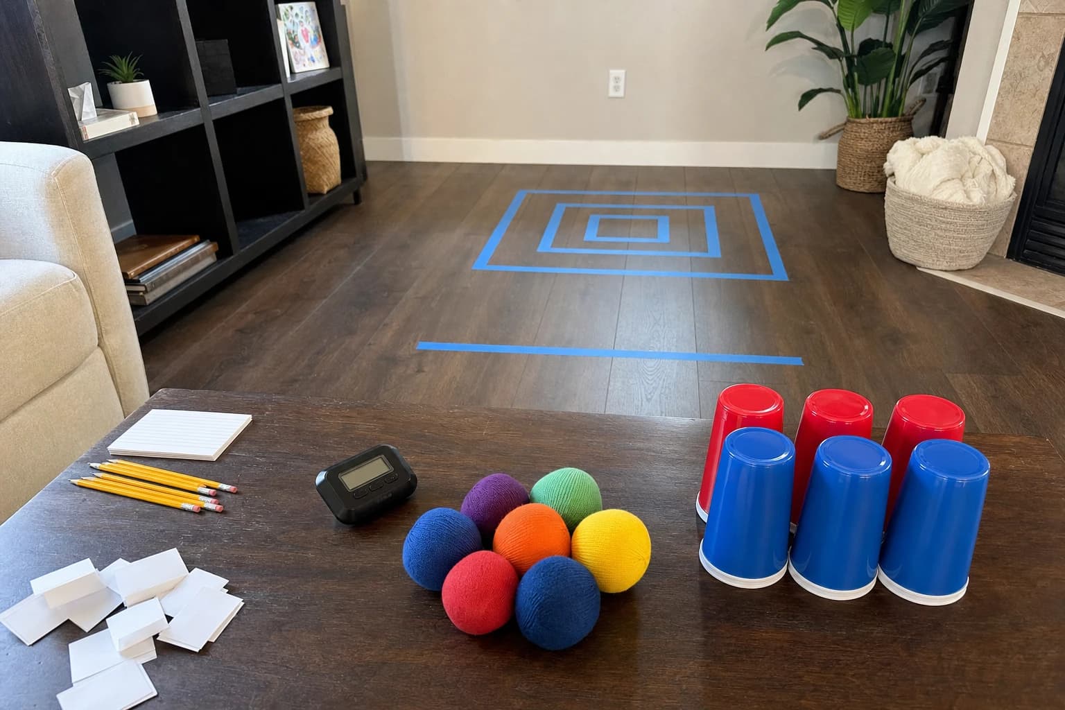 Indoor game stations with cups cards paper slips and a timer for family game night