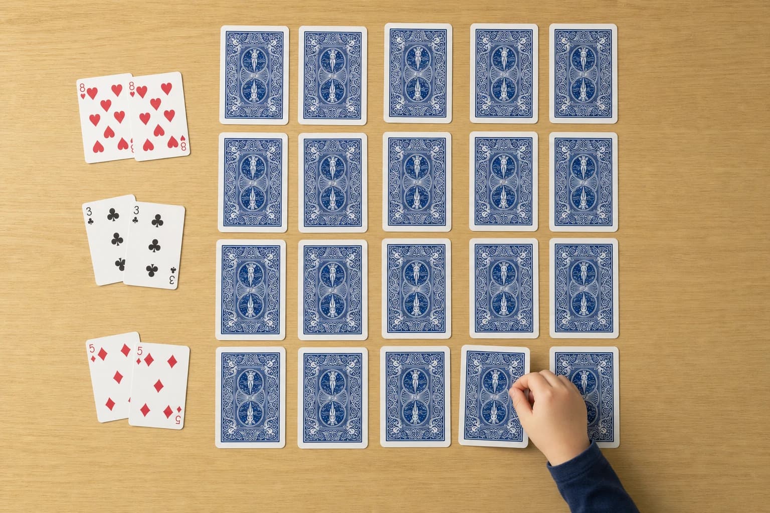 Standard playing cards arranged in simple rows for a children’s memory game