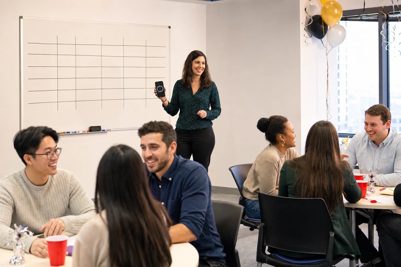Office game host using a timer and a simple score board during a team activity